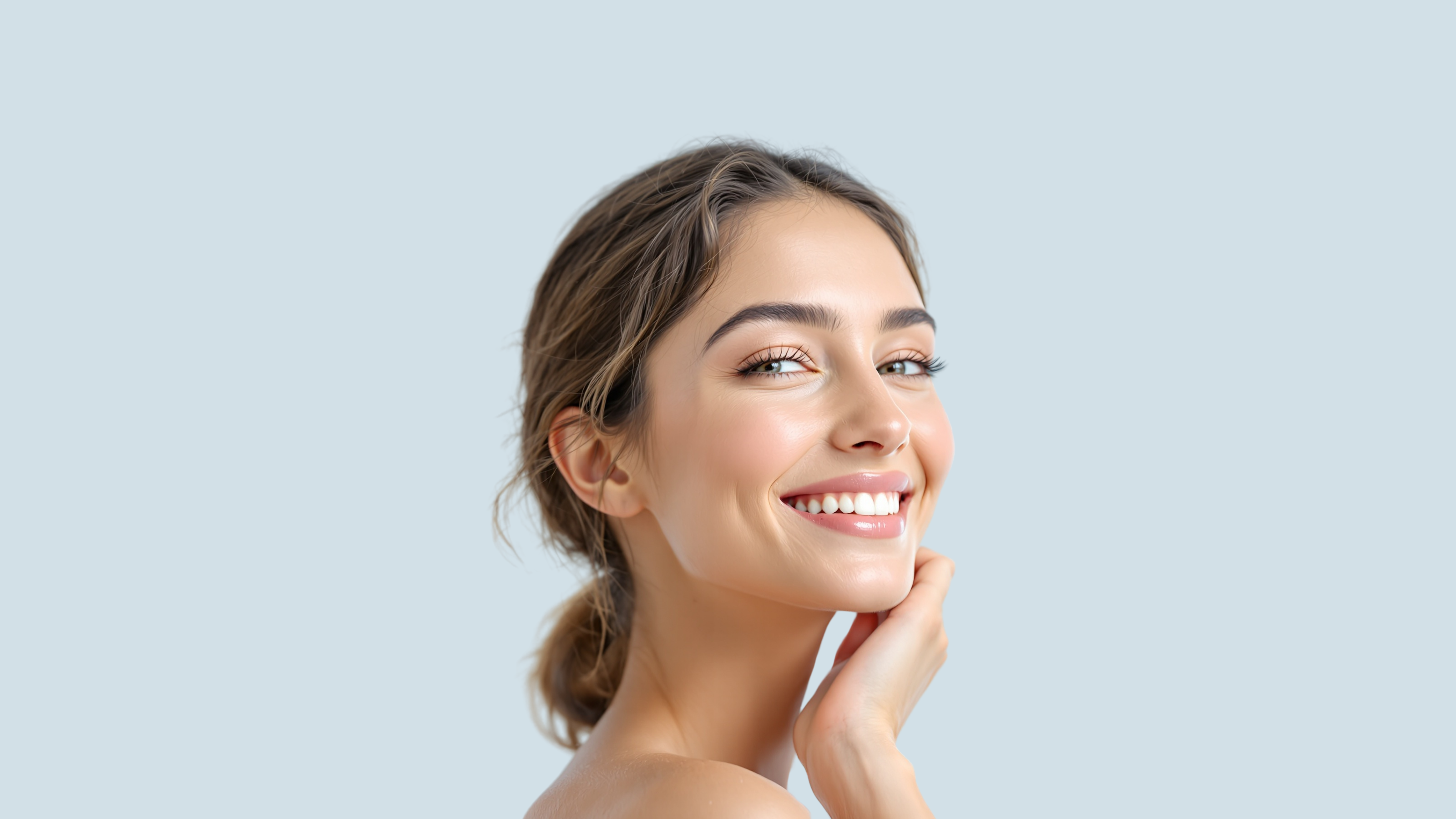 Smiling young woman with clear skin in front of a light background, symbolizing collagen skincare